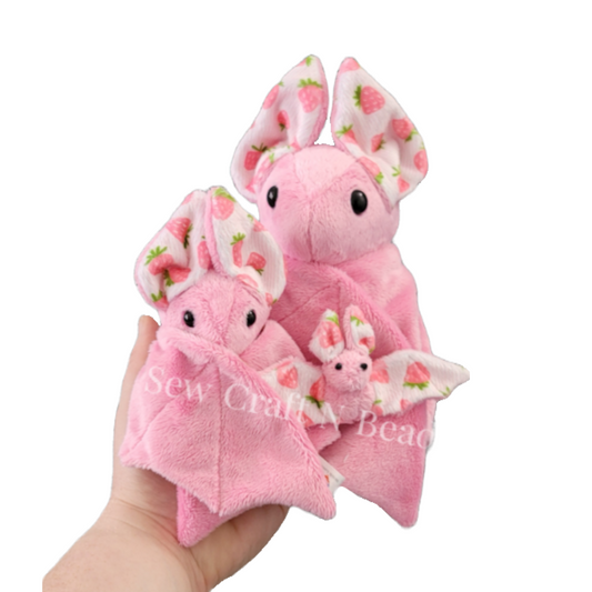 Pink Strawberry Bat plushie. Mini, Regular, and Large sizes displayed